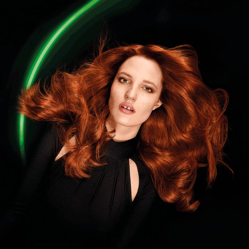 Person with vibrant hair color achieved using Loreal INOA