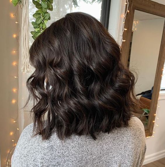 A stylist performing a down perm on a client