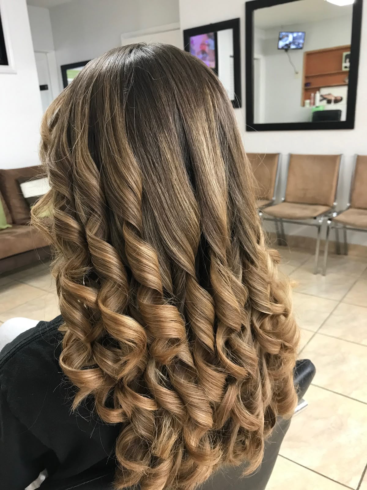 A person with defined, bouncy Wonder Curl hairstyle